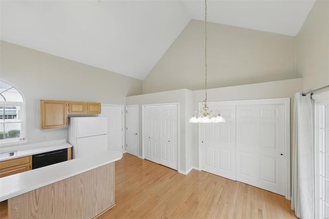 7426 Whitehall Colonial Ln, Saint Louis, MO 63119 - kitchen featuring dishwasher, freestanding refrigerator, light brown cabinetry, high vaulted ceiling, and a chandelier