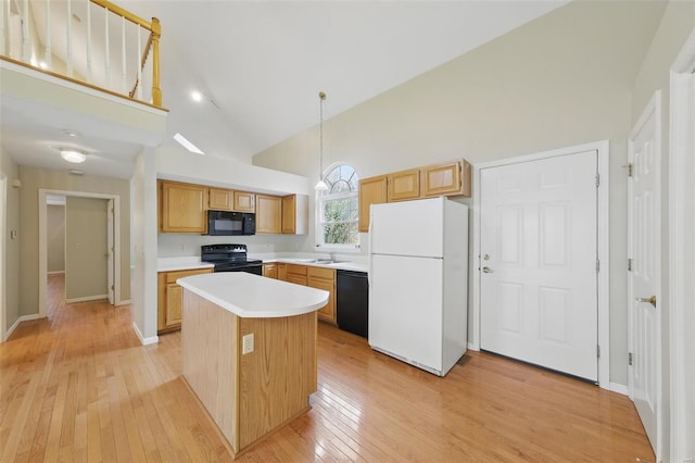 7426 Whitehall Colonial Ln, Saint Louis, MO 63119 - kitchen with black appliances, high vaulted ceiling, light wood-style floors, light countertops, and a kitchen island