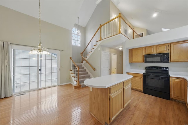 7426 Whitehall Colonial Ln, Saint Louis, MO 63119 - kitchen with black appliances, high vaulted ceiling, a chandelier, light countertops, and light wood finished floors
