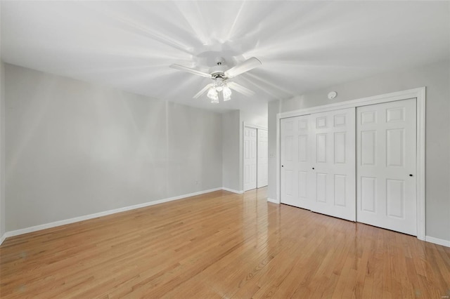 7426 Whitehall Colonial Ln, Saint Louis, MO 63119 - unfurnished bedroom featuring baseboards, light wood-style flooring, multiple closets, and ceiling fan