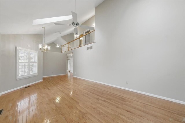 7426 Whitehall Colonial Ln, Saint Louis, MO 63119 - unfurnished living room featuring ceiling fan, baseboards, light wood-style flooring, and high vaulted ceiling