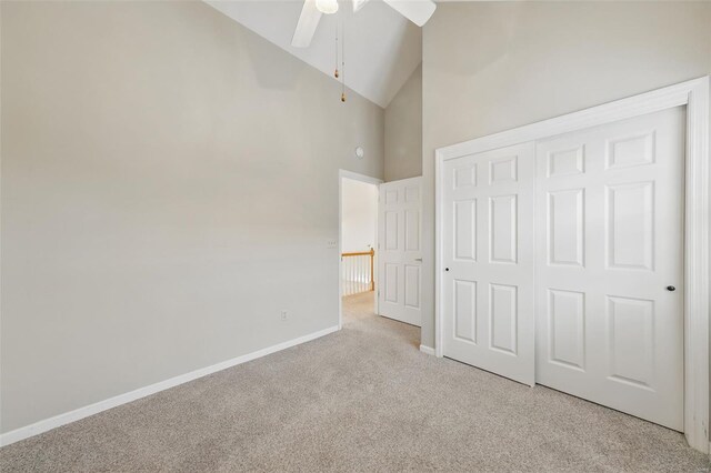 7426 Whitehall Colonial Ln, Saint Louis, MO 63119 - unfurnished bedroom with light carpet, baseboards, a closet, high vaulted ceiling, and a ceiling fan