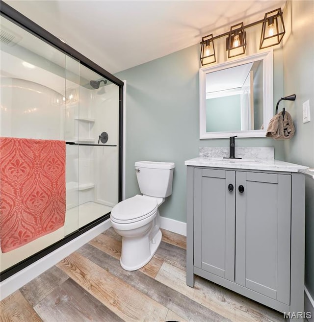 34 Moore Estates Ct, Troy, MO 63379 - full bath featuring toilet, wood finished floors, a shower stall, vanity, and baseboards