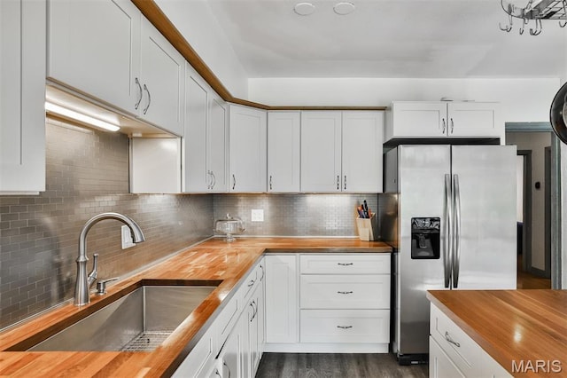 7414 Bruno Ave, Saint Louis, MO 63117 - kitchen with wooden counters, stainless steel fridge with ice dispenser, a sink, and decorative backsplash
