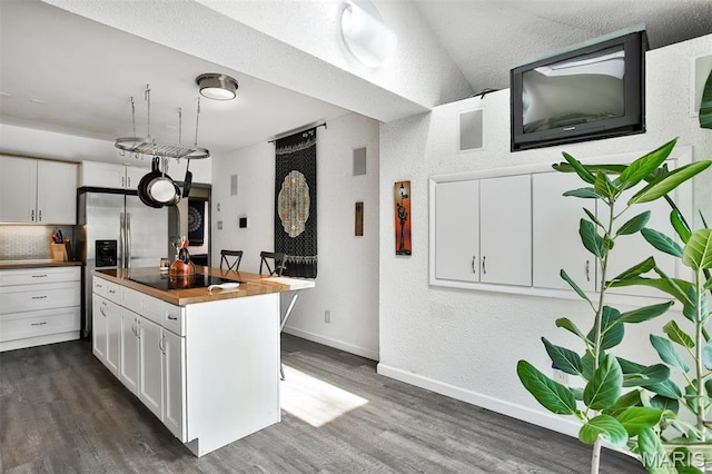 7414 Bruno Ave, Saint Louis, MO 63117 - kitchen with wooden counters, dark wood-style floors, white cabinets, stainless steel fridge, and black electric stovetop