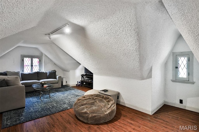 7414 Bruno Ave, Saint Louis, MO 63117 - additional living space with a textured ceiling, vaulted ceiling, wood finished floors, and baseboards