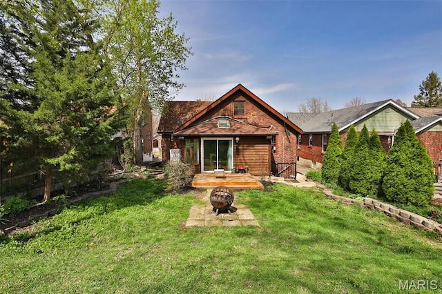 7414 Bruno Ave, Saint Louis, MO 63117 - rear view of property with a fire pit, a lawn, and brick siding
