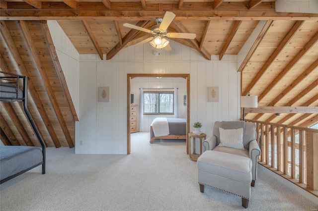 living area featuring wood ceiling, ceiling fan, carpet floors, and wood walls
