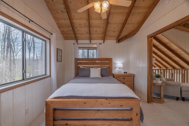bedroom with carpet floors, multiple windows, wood ceiling, wooden walls, and a ceiling fan