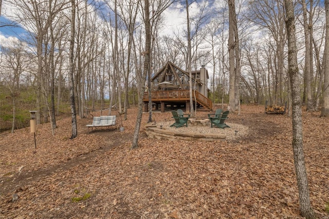 view of yard featuring a deck and stairs