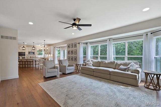 472 Cypress Creek Ln, Imperial, MO 63052 - living room with a ceiling fan, a chandelier, dark wood-style flooring, recessed lighting, and baseboards