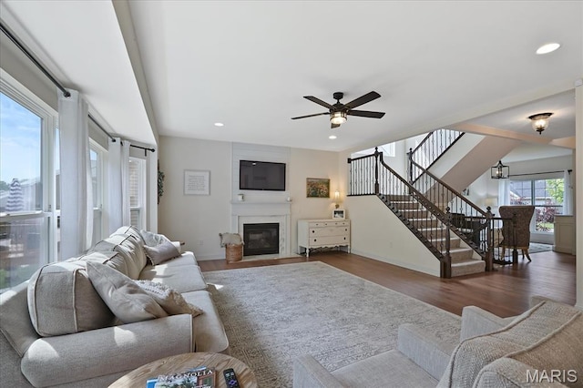 472 Cypress Creek Ln, Imperial, MO 63052 - living room featuring wood finished floors, a fireplace with flush hearth, baseboards, ceiling fan, and recessed lighting