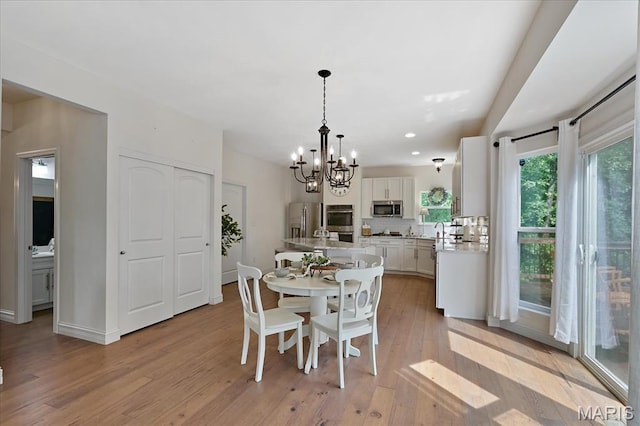 472 Cypress Creek Ln, Imperial, MO 63052 - dining area featuring a chandelier, light wood-style floors, recessed lighting, and baseboards