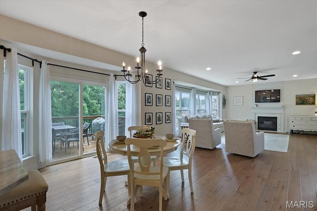 472 Cypress Creek Ln, Imperial, MO 63052 - dining room with wood-type flooring, a glass covered fireplace, recessed lighting, a ceiling fan, and a chandelier