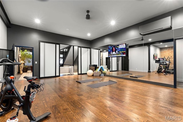429 N Euclid Ave, Saint Louis, MO 63108 - exercise room with a wall mounted AC, wood finished floors, recessed lighting, and baseboards