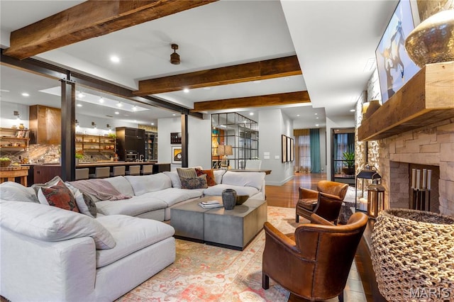 429 N Euclid Ave, Saint Louis, MO 63108 - living area with recessed lighting, beam ceiling, baseboards, a stone fireplace, and light wood-style flooring