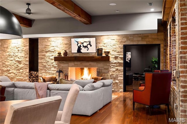 429 N Euclid Ave, Saint Louis, MO 63108 - living area featuring beamed ceiling, wood finished floors, a lit fireplace, and a ceiling fan