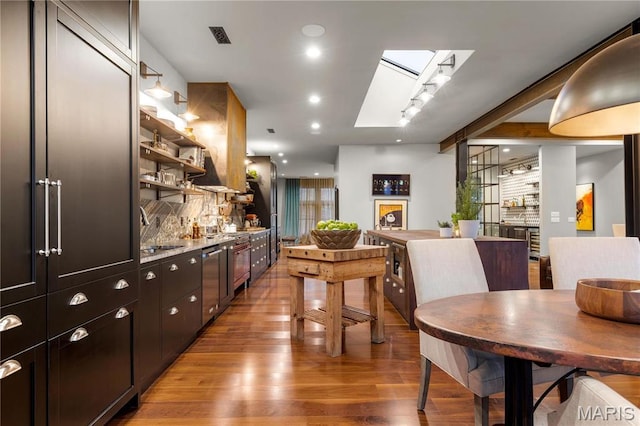 429 N Euclid Ave, Saint Louis, MO 63108 - dining room with light wood-style flooring, track lighting, and a bar