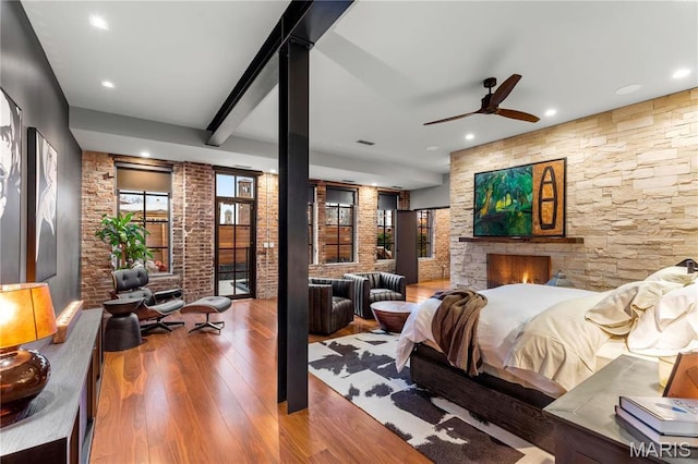 429 N Euclid Ave, Saint Louis, MO 63108 - bedroom with wood finished floors, recessed lighting, a stone fireplace, and beam ceiling
