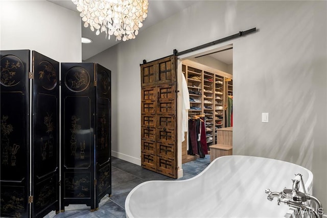 429 N Euclid Ave, Saint Louis, MO 63108 - bathroom with a soaking tub, a walk in closet, baseboards, and a chandelier