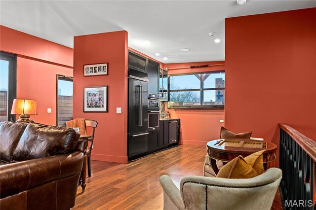 429 N Euclid Ave, Saint Louis, MO 63108 - living room featuring dark wood-style flooring, recessed lighting, and baseboards