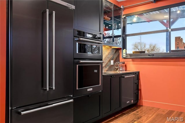 429 N Euclid Ave, Saint Louis, MO 63108 - kitchen featuring high quality fridge, wood finished floors, double wall oven, dark cabinetry, and baseboards