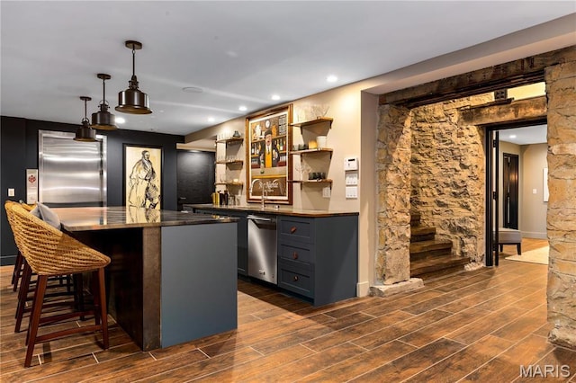 429 N Euclid Ave, Saint Louis, MO 63108 - indoor bar with stainless steel appliances, dark wood-style flooring, stairs, hanging light fixtures, and recessed lighting