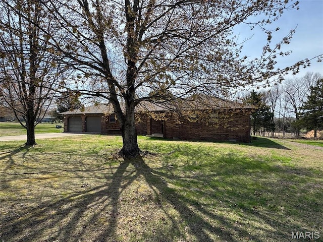 19924 Goldenwood Rd, Lebanon, MO 65536 - view of front of home featuring concrete driveway, an attached garage, a front lawn, and brick siding