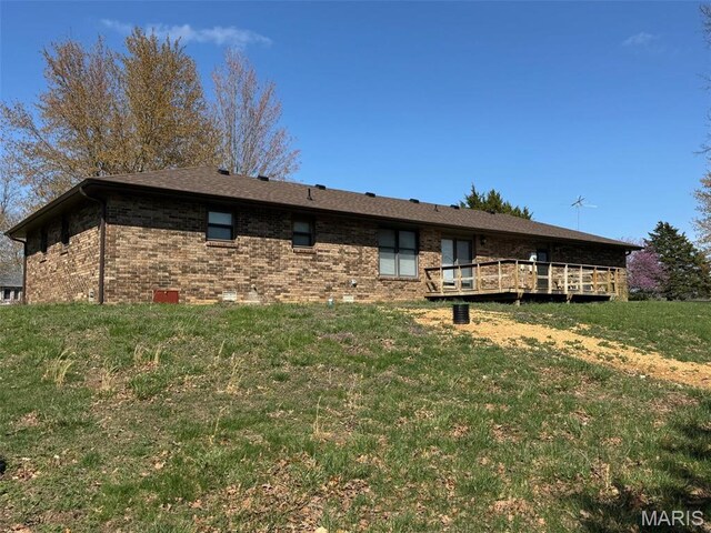19924 Goldenwood Rd, Lebanon, MO 65536 - back of house featuring a deck, brick siding, and a lawn