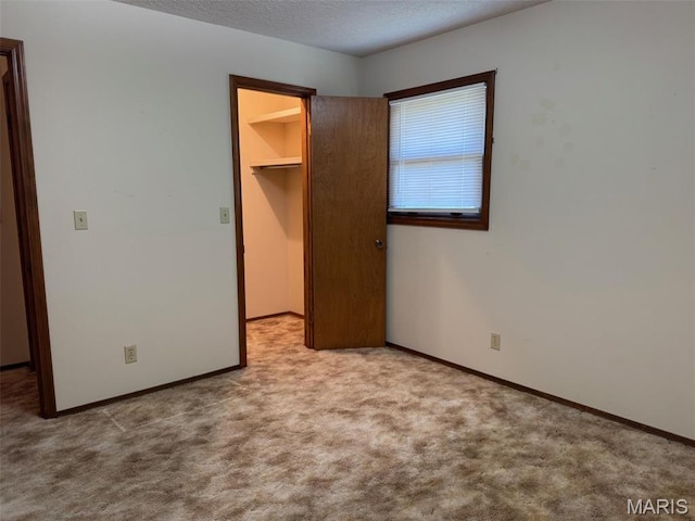 19924 Goldenwood Rd, Lebanon, MO 65536 - unfurnished bedroom featuring a spacious closet, carpet flooring, a closet, and a textured ceiling