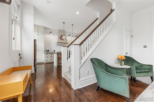 stairs featuring hardwood / wood-style flooring, recessed lighting, and baseboards