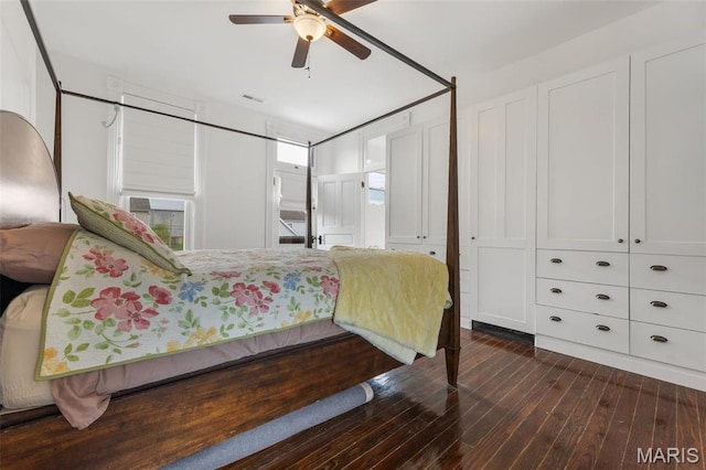 bedroom with dark wood-style floors and a ceiling fan