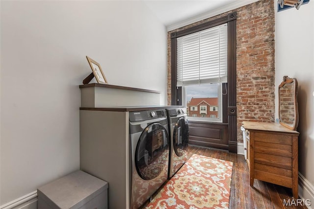 washroom with washing machine and clothes dryer and dark wood-type flooring
