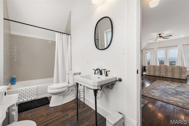 bathroom featuring toilet, wood finished floors, ceiling fan, connected bathroom, and shower / bath combo with shower curtain