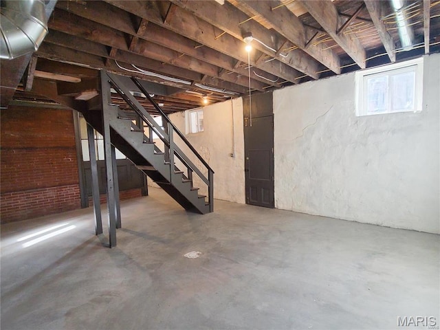 basement with healthy amount of natural light and stairs
