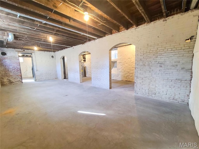 below grade area with brick wall and arched walkways