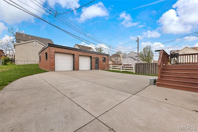 view of side of home with brick siding and a detached garage