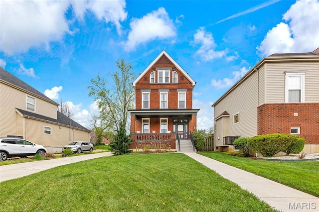 view of front of property with covered porch and a front lawn