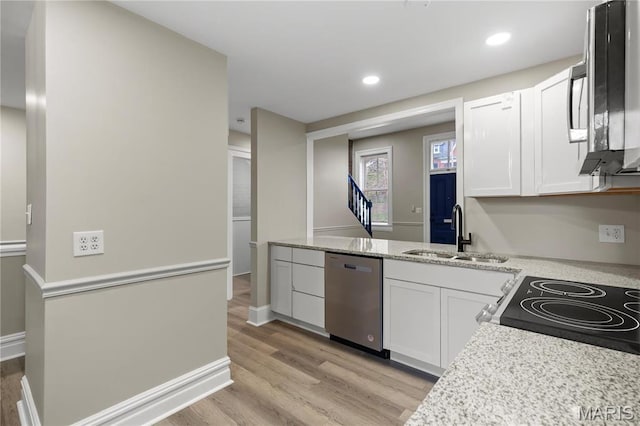 914 Russell Blvd, Saint Louis, MO 63104 - kitchen with stainless steel appliances, light wood-style floors, white cabinetry, recessed lighting, and light stone countertops