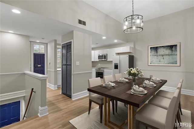 914 Russell Blvd, Saint Louis, MO 63104 - dining space featuring light wood finished floors, a chandelier, and recessed lighting