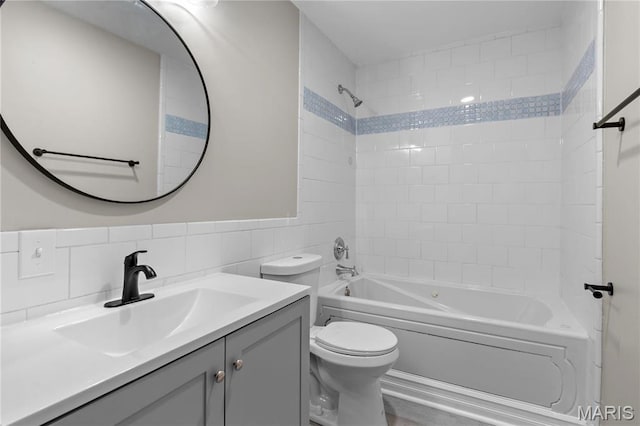 914 Russell Blvd, Saint Louis, MO 63104 - bathroom featuring tile walls, vanity, shower / tub combination, and a wainscoted wall