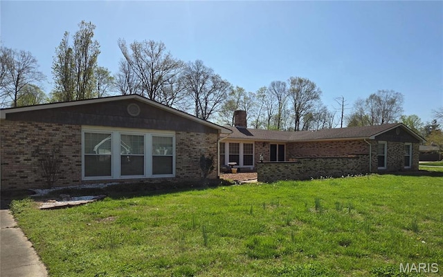 185 Garnet Ln, Cape Girardeau, MO 63701 - rear view of property with a chimney, brick siding, and a lawn