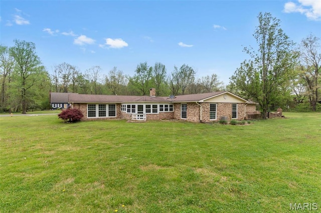 185 Garnet Ln, Cape Girardeau, MO 63701 - back of property featuring a chimney, a yard, and brick siding