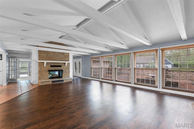 185 Garnet Ln, Cape Girardeau, MO 63701 - unfurnished living room featuring a stone fireplace, wood finished floors, and baseboards