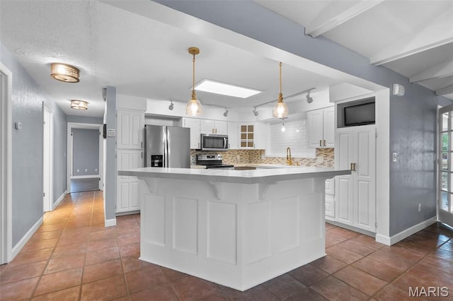 185 Garnet Ln, Cape Girardeau, MO 63701 - kitchen with appliances with stainless steel finishes, white cabinetry, light countertops, and tasteful backsplash