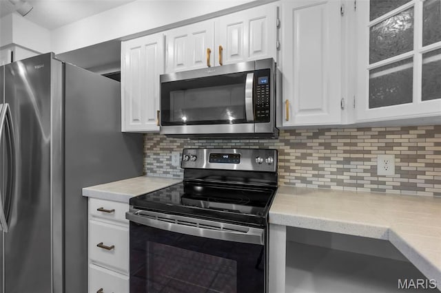185 Garnet Ln, Cape Girardeau, MO 63701 - kitchen featuring stainless steel appliances, light countertops, white cabinetry, and decorative backsplash