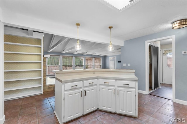 185 Garnet Ln, Cape Girardeau, MO 63701 - kitchen featuring white cabinets, healthy amount of natural light, decorative light fixtures, light countertops, and beam ceiling
