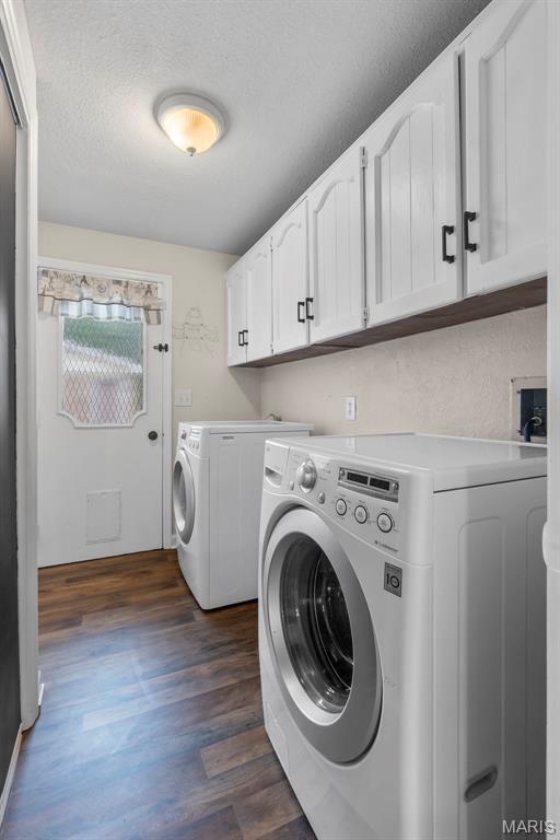 185 Garnet Ln, Cape Girardeau, MO 63701 - laundry room with cabinet space, washer and clothes dryer, dark wood-style floors, and a textured ceiling