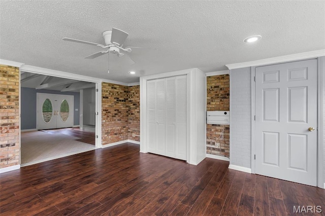 185 Garnet Ln, Cape Girardeau, MO 63701 - unfurnished living room with brick wall, ceiling fan, a textured ceiling, wood finished floors, and baseboards