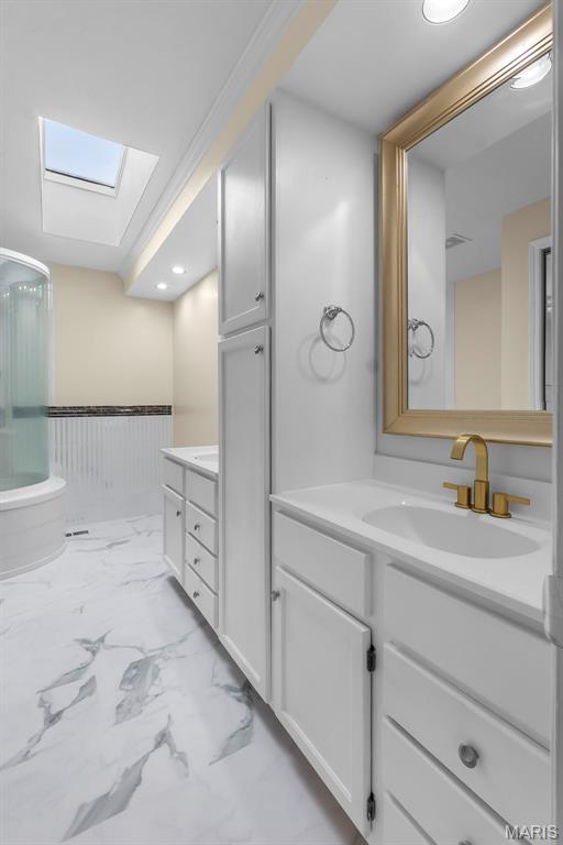 185 Garnet Ln, Cape Girardeau, MO 63701 - bathroom with a skylight, vanity, marble look tiles, and a shower
